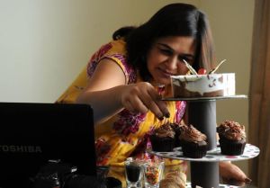 Monika setting a cake